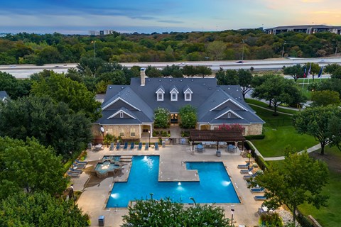 an aerial view of a mansion with a swimming pool and a house